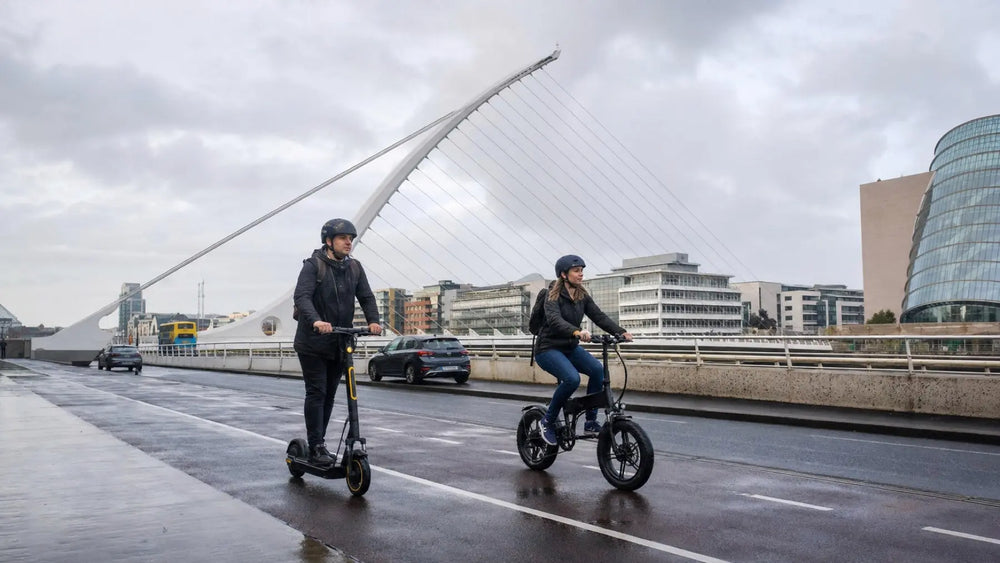 Electric scooter and folding e-bike commuters beside Samuel Beckett Bridge in Dublin